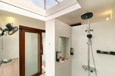 a bathroom with a shower with a glass door at PROMO Modern Seminyak Pvt Villa with Pool and Parking in Seminyak
