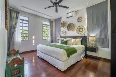 a bedroom with a large bed and a ceiling fan at Villa Alchemy Private 4 BR Eat Street 10 steps to Revolver Cafe in Seminyak