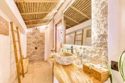 a bathroom with a sink and a mirror at Villa Indigo - 5-BDR with huge pool and garden in Seminyak