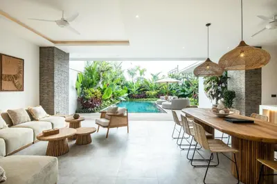 an open living room with a table and chairs at Coastal Elegance 4BR Villa, 400m to Finns in Canggu