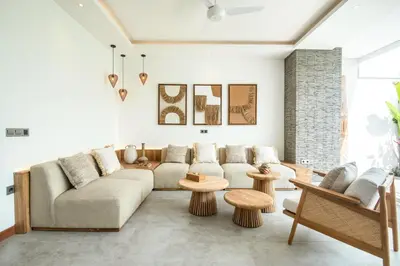a living room with a couch and tables at Coastal Elegance 4BR Villa, 400m to Finns in Canggu