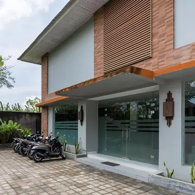 a group of motorcycles parked in front of a house at Cove Matahari Guesthouse Sunset in Legian