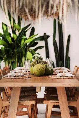 a wooden table with fruit and wine glasses on it at Villa Obao in Seminyak