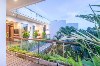a house with a balcony with plants at Incredible 4BR Villa 5 mins walk to the beach in Canggu
