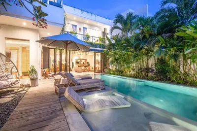 a swimming pool in a villa with a house at Incredible 4BR Villa 5 mins walk to the beach in Canggu