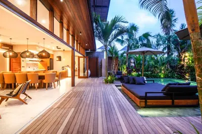 an open living room with a couch and a dining room at Elegant 6BR Villa, Canggu, 400m to Finns Beach in Canggu