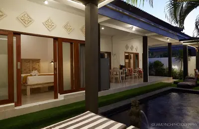 a house with a swimming pool and a bedroom at Villa Ari in Seminyak