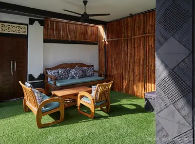 a living room with a table and chairs and a couch at Villa Ari in Seminyak