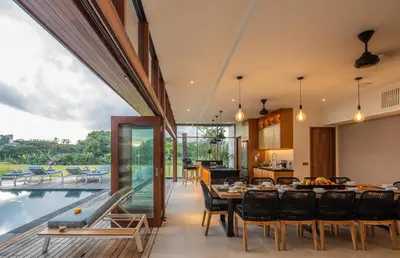 a kitchen and dining room with a table and a pool at Marvelous 6BR, Panoramic Views, Ultimate Luxury in Canggu