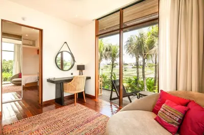 a living room with a couch and a table at Marvelous 6BR, Panoramic Views, Ultimate Luxury in Canggu