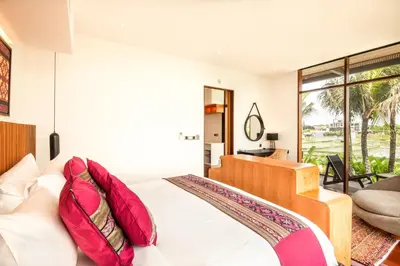 a bedroom with a bed with red pillows at Marvelous 6BR, Panoramic Views, Ultimate Luxury in Canggu