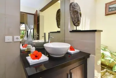 a bathroom with two sinks and a large bowl sink at Villa Intan in Legian