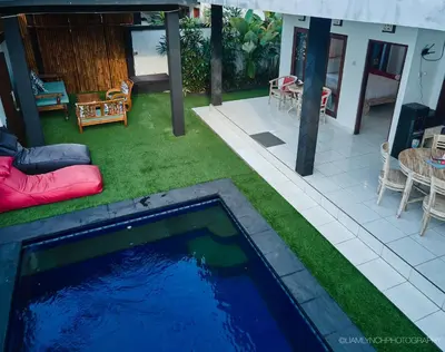 a swimming pool in the yard of a house at Villa Kaya in Seminyak