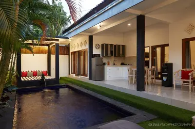 a house with a backyard with a pool and a kitchen at Massive 6-bedroom Villa with 2 Pools in Seminyak