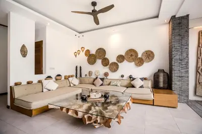 a living room with a couch and a table at Villa Ara by BaliSuperHost in Seminyak