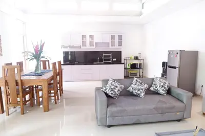 a living room with a couch and a table at Villa Bristol in Seminyak