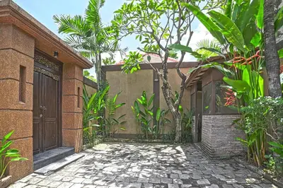 a brick house with a gate and a walkway at Villa Searenity Seminyak in Seminyak