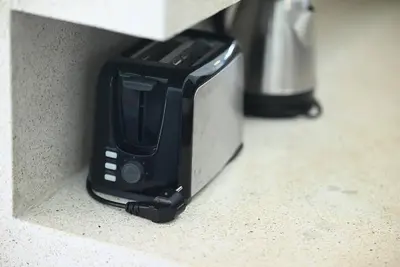 a black toaster sitting on top of a counter at Villa Searenity Seminyak in Seminyak