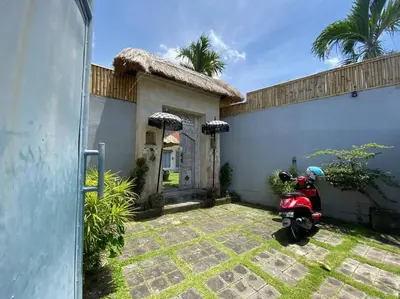 a scooter parked in front of a house at Villa Dharsan in Seminyak