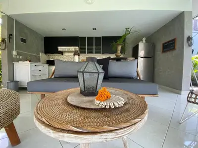 a living room with a couch and a table at Villa Dharsan in Seminyak