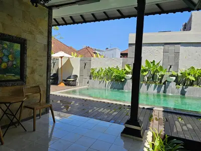 a view of a swimming pool from the patio of a house at Rabasta Enjoy Kuta in Denpasar
