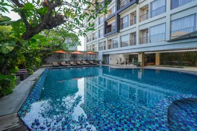 a swimming pool in front of a building at Brits Hotel Legian in Seminyak
