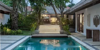a swimming pool in front of a house at Large 6-Bedroom Private Villa with Pool for Groups & Families - Umalas in Kerobokan