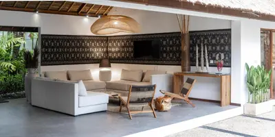 a living room with a couch and a table and chairs at Large 6-Bedroom Private Villa with Pool for Groups & Families - Umalas in Kerobokan