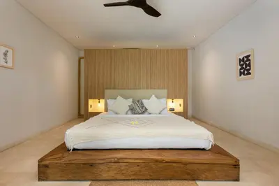 a bedroom with a large bed and a ceiling fan at Villa Reina by SooBali - Spacious & Modern near Canggu with Butler-Cook, Private Pool and Tropical Gardens in Kerobokan