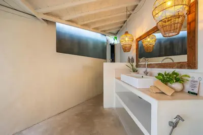a bathroom with a sink and a mirror at Villa Tarita Canggu in Kerobokan