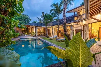 an exterior view of a house with a swimming pool at Villa Tarita Canggu in Kerobokan