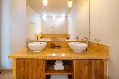 a bathroom with two sinks and a large mirror at Villa Panchajanya - Seminyak in Seminyak