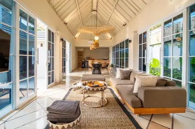 a living room with a couch and a table at Villa Panchajanya - Seminyak in Seminyak