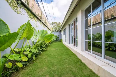 an internal courtyard of a building with plants at Villa Panchajanya - Seminyak in Seminyak