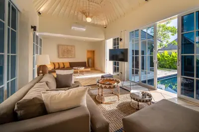 a living room with a couch and a tv at Villa Panchajanya - Seminyak in Seminyak
