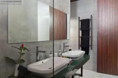 a bathroom with two sinks and a mirror at 8BR Villa Jumis - Minggu Villas Seminyak in Seminyak