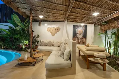 a living room with a couch and a painting on the wall at Villa Lagertha by Optimum Bali Villas in Kerobokan