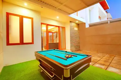 a room with a pool table in a house at Villa Noam By Bali Asia Villa in Jimbaran