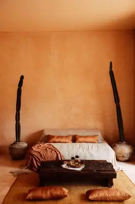 a room with a bed and a table with pillows at The Oasis Bali in Canggu
