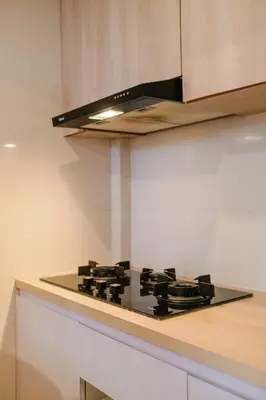 a kitchen with a black stove top in a kitchen at The Hita Apartement in Seminyak