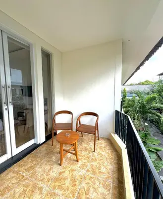 two chairs and a table on a balcony at The Hita Apartement in Seminyak
