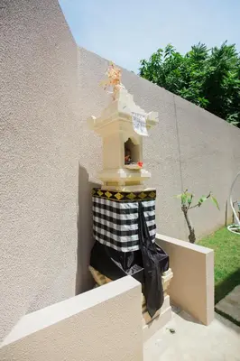 a bird house on the side of a wall at Donguri House Bali in Jimbaran