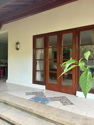 an entrance to a house with wooden doors at Villa Abhista Seminyak in Seminyak