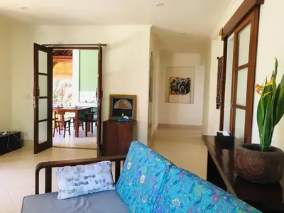a living room with a couch and a dining room at Villa Abhista Seminyak in Seminyak