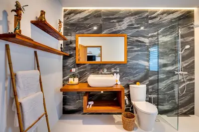 a bathroom with a sink and a mirror at Malinda Villa Seminyak in Seminyak