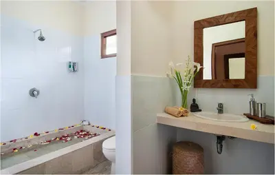 a bathroom with a sink and a toilet and a mirror at 6BR Villa Sensel - Minggu Villas Seminyak in Seminyak