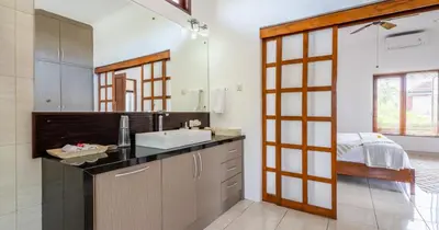 a bathroom with a sink and a mirror at Taman Hijau Villa by iBali Management in Kerobokan