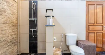a bathroom with a toilet and a shower at Taman Hijau Villa by iBali Management in Kerobokan