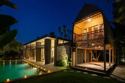 a villa with a swimming pool at night at Villa Deh Simba at Seminyak Aramanis in Seminyak