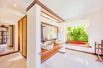 a bathroom with two sinks and a tub at Villa Jalamati in Seminyak